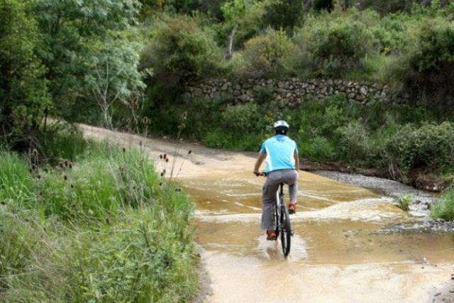  cyclist traveling along a sandy path 